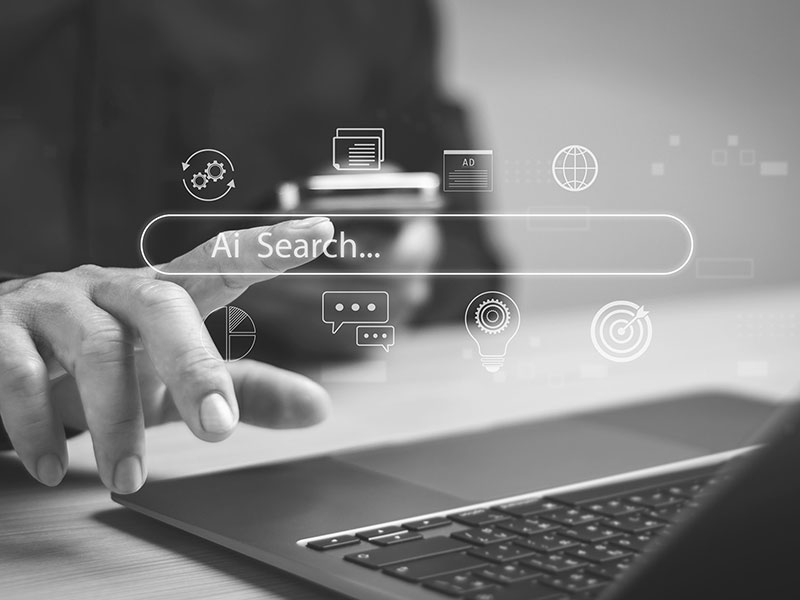 Close-Up of Laptop Keyboard with AI Search Graphic Overlay